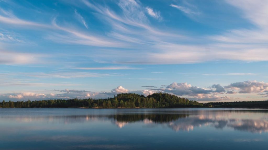A wide shot of sweeping, feathery skies over a lake in Latvia