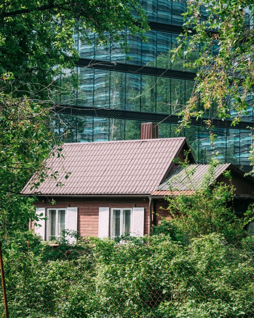 Traditionally built Danish house right in front of a glass high rise