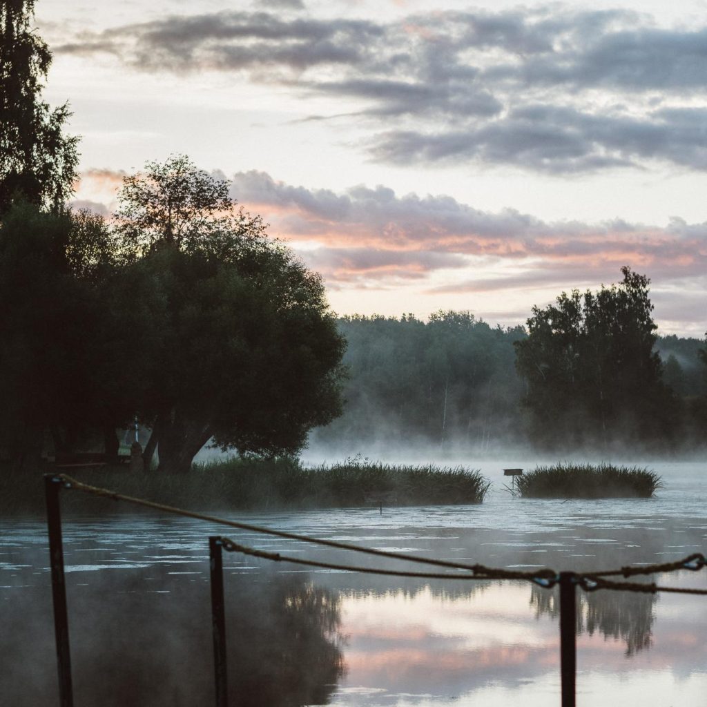 Lake in the early morning hours that makes the water transform into low fog